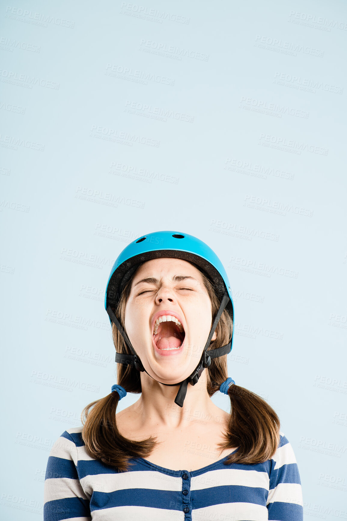 Buy stock photo Cycling, helmet and woman with scream in studio space with voice, noise and aesthetic style with mockup. Shout, emotion and frustrated cyclist with protest, energy and gen z girl on blue background