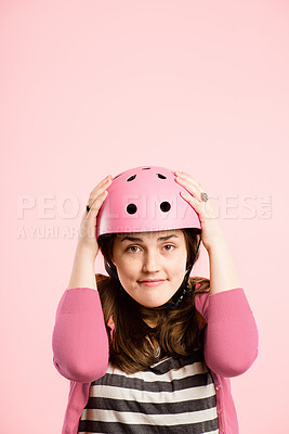 Buy stock photo Cycling, helmet and portrait of girl in studio with confidence, travel or retro aesthetic style on mockup. Bike, safety and serious face of woman with transport, casual and fashion on pink background