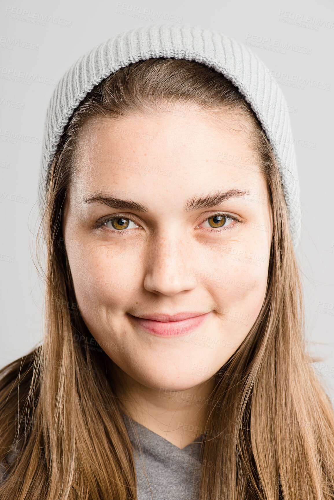 Buy stock photo Happy, beanie and portrait of woman on gray background with stylish, trendy accessory and winter clothes. Fashion, smile and face of isolated person with cap in studio for confidence, pride and warm