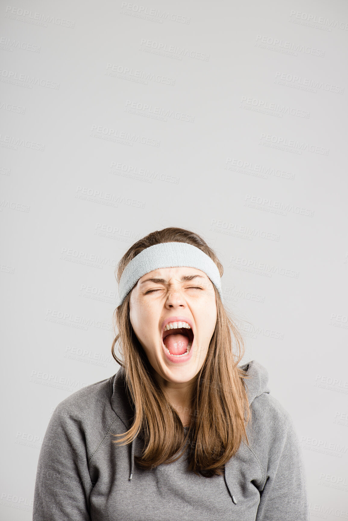 Buy stock photo Shouting, screaming and face of woman in studio with anger, upset and crazy reaction. Body language, facial expression and isolated person with loud noise, voice and announcement on gray background