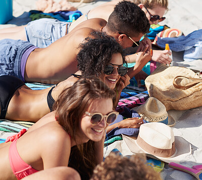 Buy stock photo Shot of a group of friends spending time on the beach