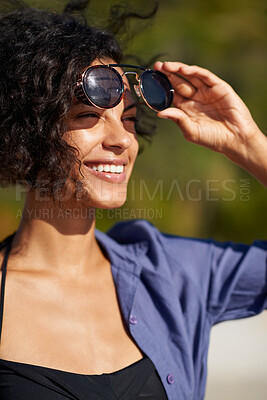 Buy stock photo Shot of a young woman enjoying the sun at the beach