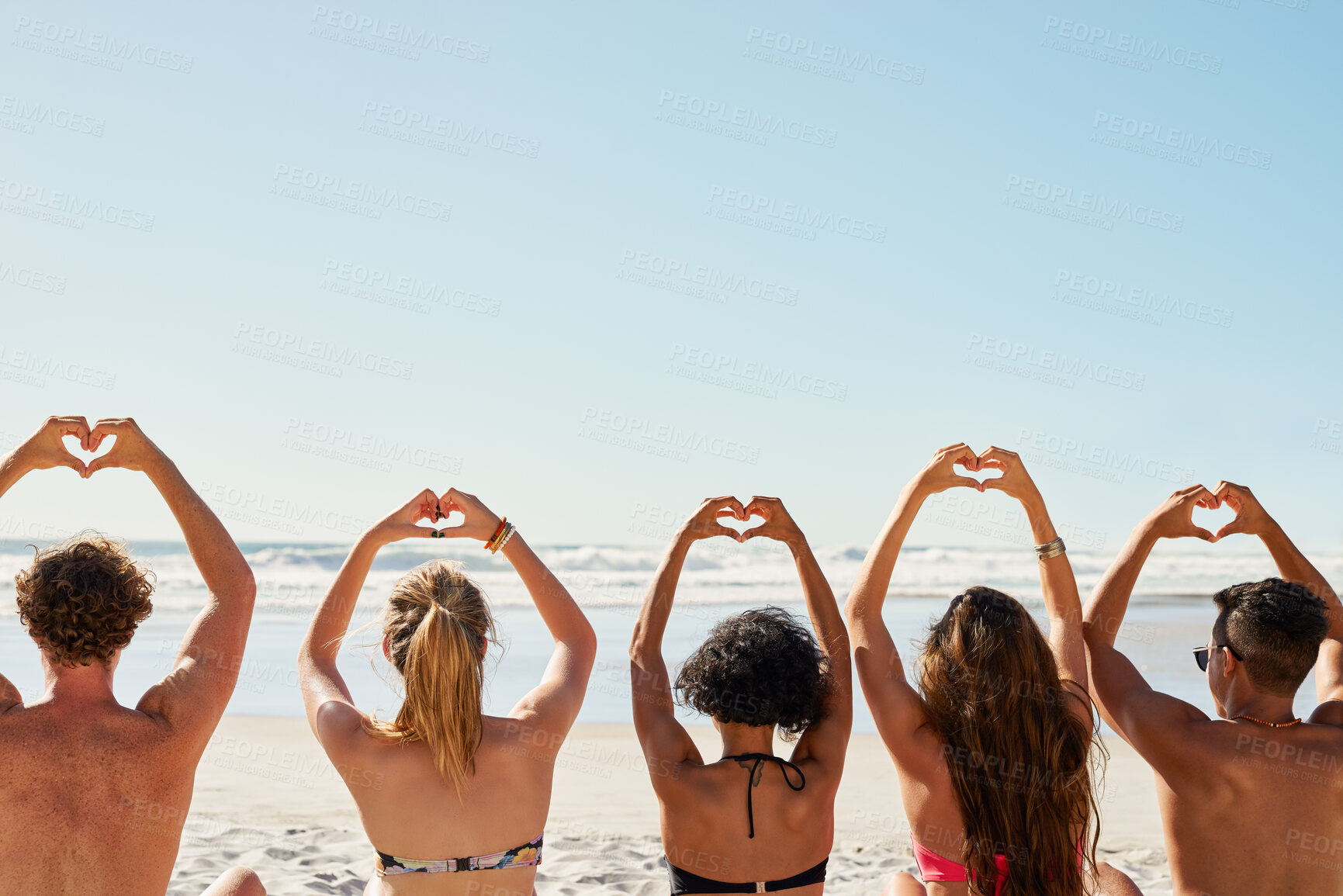 Buy stock photo Travel, hands in heart and friends at beach for summer holiday, tropical vacation and weekend outdoors. Mockup space, blue sky and back of men and women by ocean with emoji, love sign and gesture