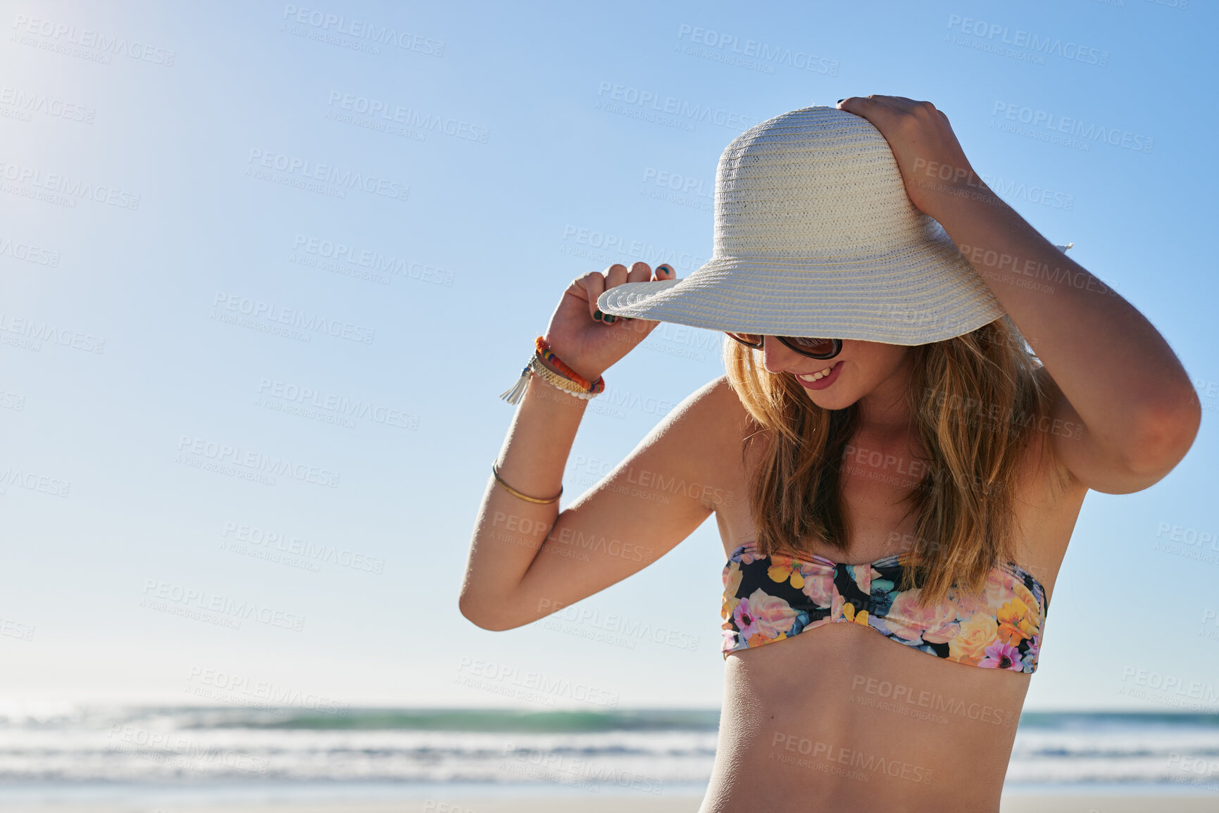 Buy stock photo Woman, happy and hat outdoor at beach for tropical holiday, adventure and summer vacation. Tourist, person and sunglasses at ocean for travel, relax and break with eyewear and fun on mockup space