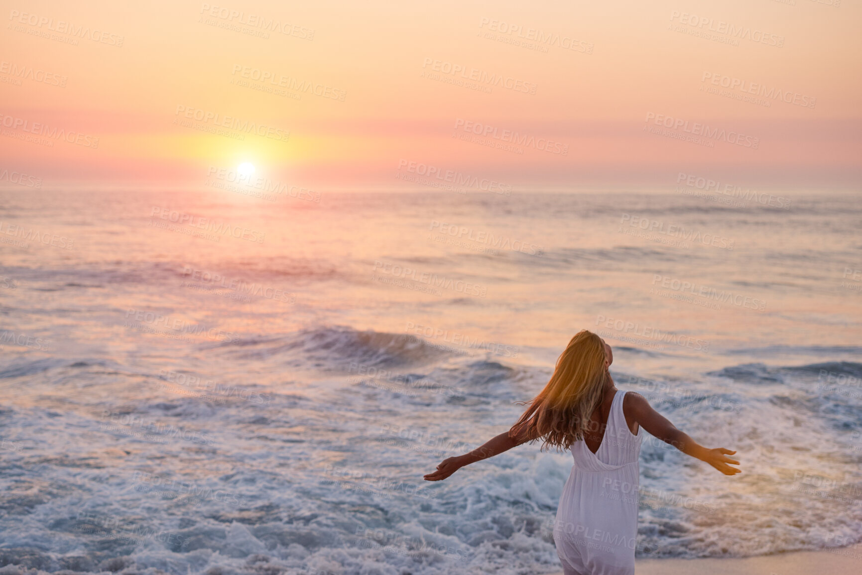 Buy stock photo Woman, freedom and sunset with waves at beach for fresh air, relax and travel adventure with gratitude. Back, person and stretching arms at ocean with holiday, summer vacation and peaceful journey