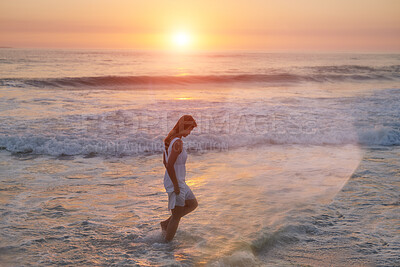 Buy stock photo Sunset, waves and woman on beach for walking, vacation holiday and adventure with peace by space. Female person, wellness and health by water for relaxing, serene and dusk evening with confidence