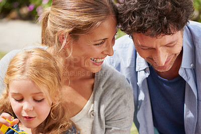 Buy stock photo Parents, girl child and bubbles in garden with bonding, relax or playful with smile for family memory in summer. Father, mother and daughter in home backyard with connection, care and love in Germany