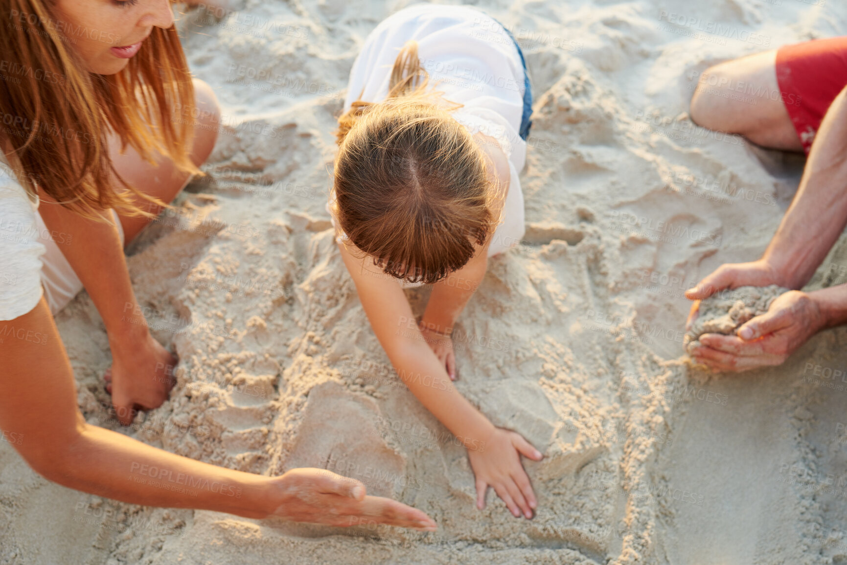 Buy stock photo Parents, girl and kid at beach with sandcastle, playful and bonding with family, love and above on vacation. Father, mother and daughter with care, building and games on ground for learning in Spain