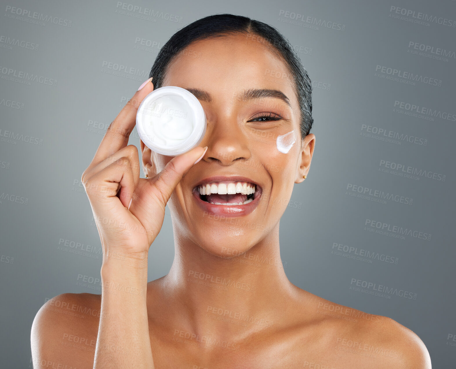 Buy stock photo Woman, skin cream and container in studio portrait with smile, wellness and beauty by background. Girl, person and model with cosmetics, serum and moisturizer product for transformation in Colombia