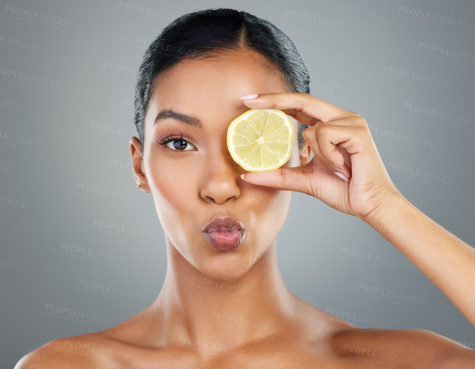 Buy stock photo Woman, portrait and lemon with vitamin C for skincare, beauty or healthy cosmetics on a gray studio background. Young, female person or model with organic, natural or citrus fruit for antioxidant