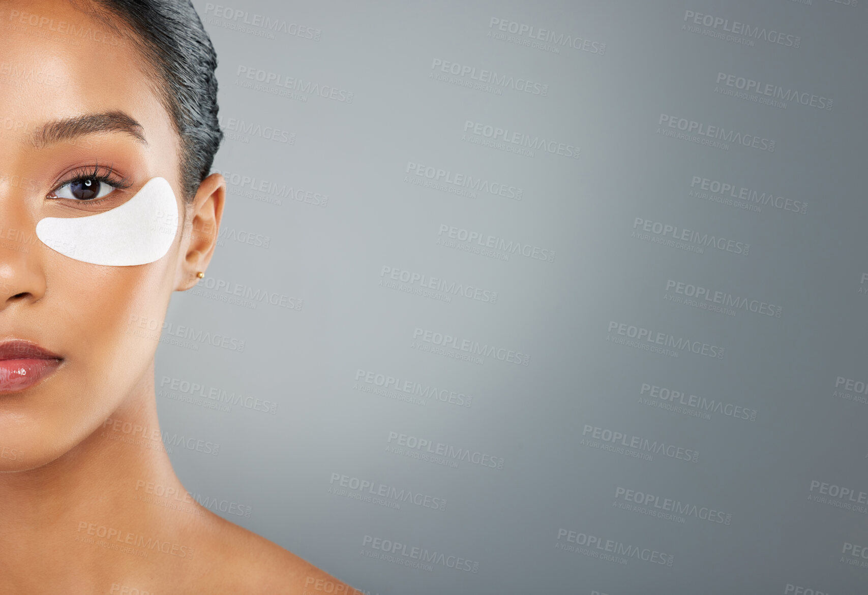 Buy stock photo Woman, portrait and eye patch with skincare for facial cosmetics, hydrogen or anti aging on a gray studio background. Young, female person or model with skin application for vitamin C on mockup space