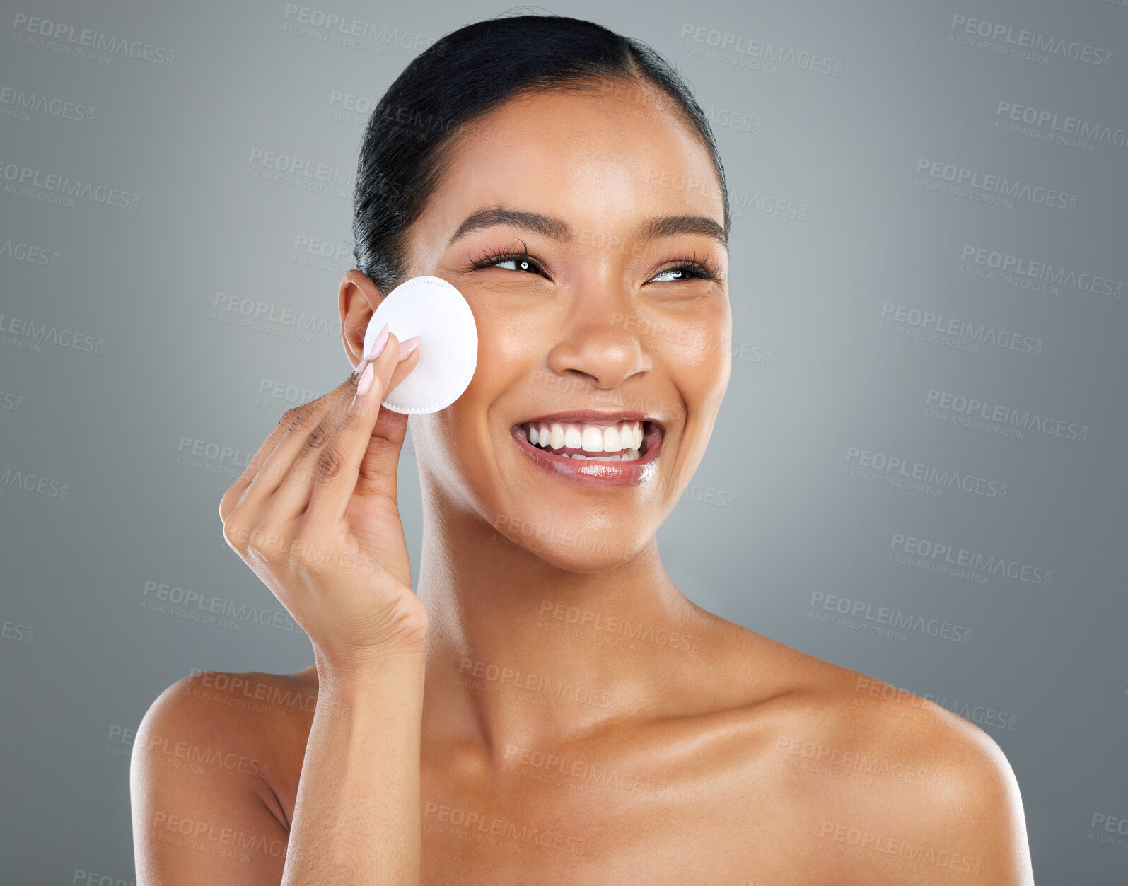 Buy stock photo Happy woman, beauty and cotton pad with skincare for facial hygiene or anti aging on a gray studio background. Young face, female person or model with smile for makeup removal or cleaning treatment