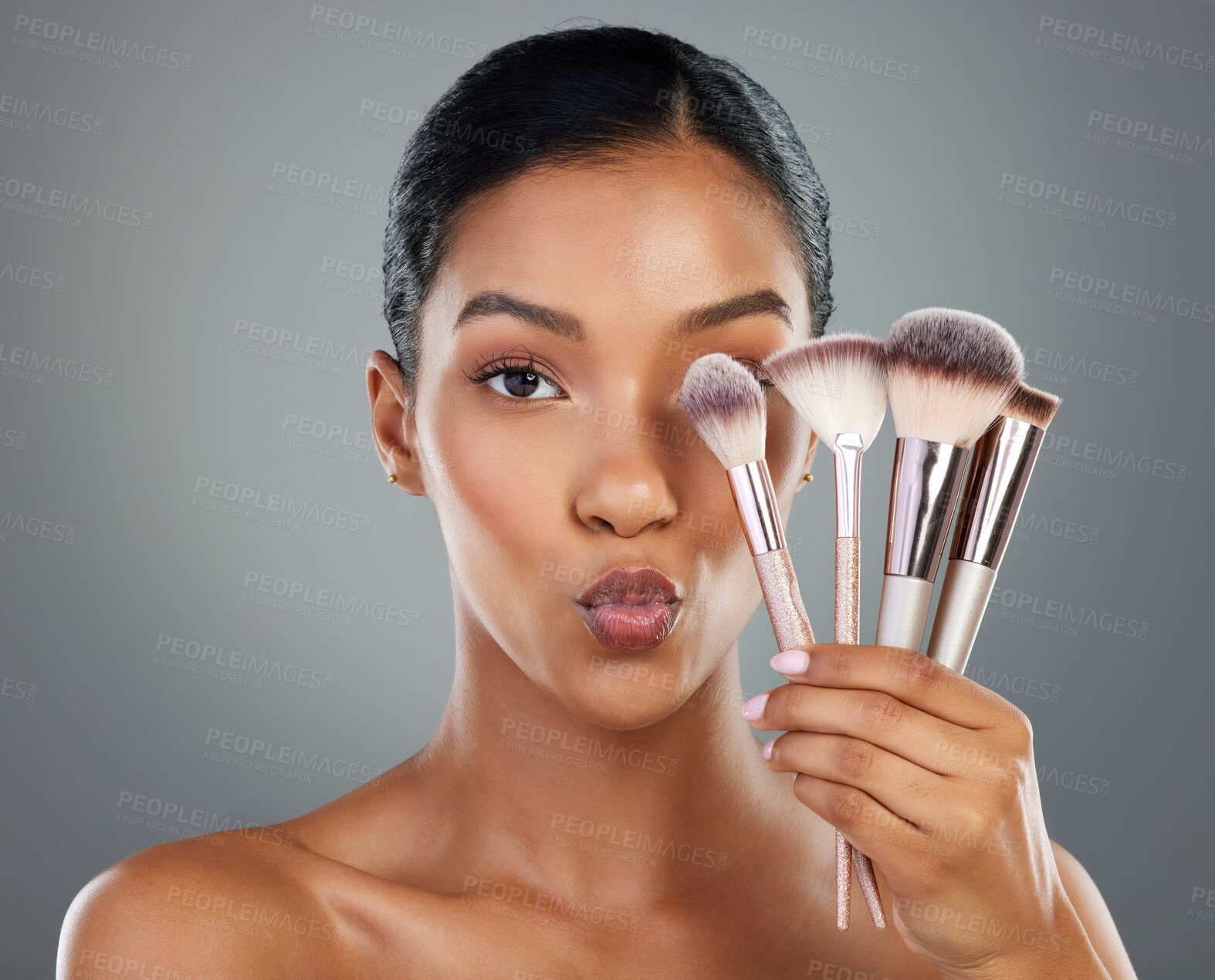 Buy stock photo Woman, portrait and beauty with makeup brushes for cosmetics or facial on a gray studio background. Young, female person or model with face equipment, utensils or tools for beautician or makeover