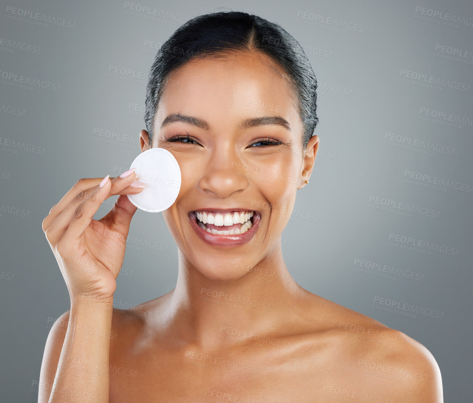 Buy stock photo Happy woman, portrait and cotton pad with skincare for facial hygiene or anti aging on a gray studio background. Young, female person or model with smile for makeup removal or cleaning treatment