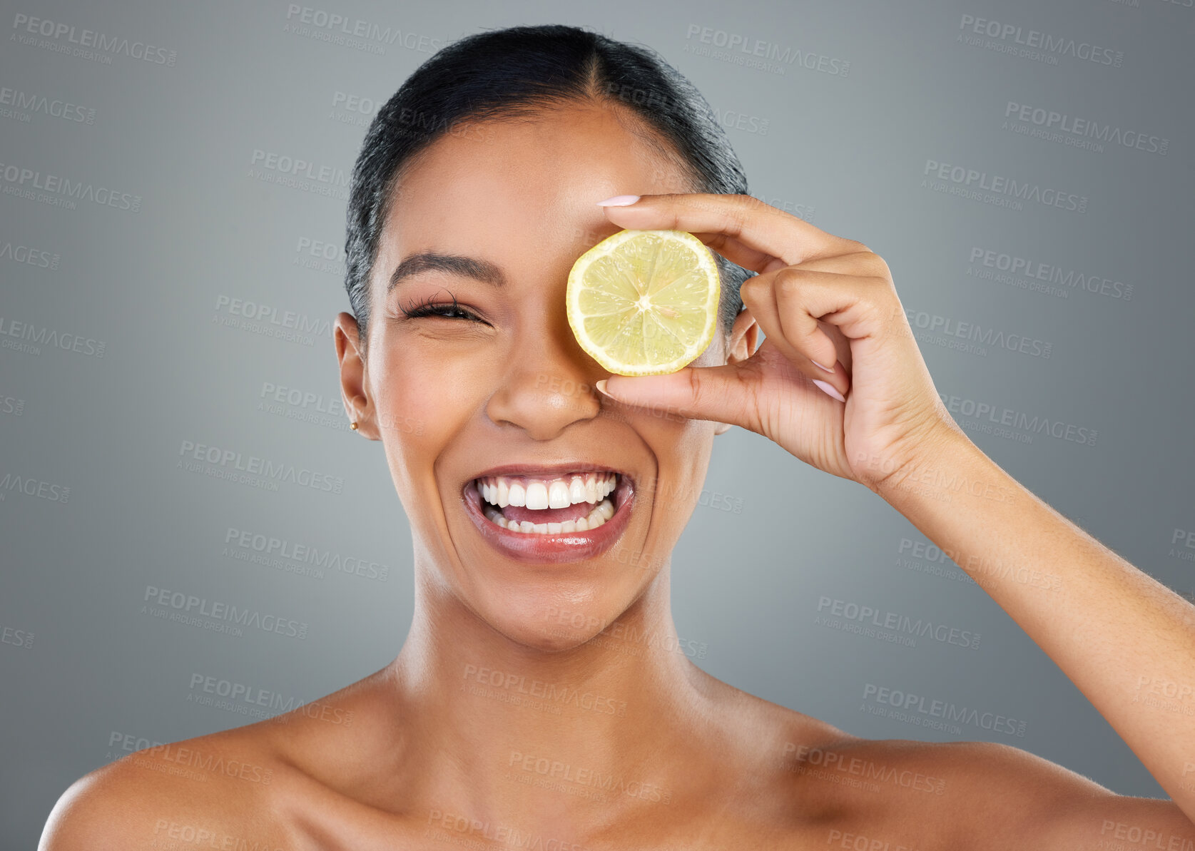 Buy stock photo Happy woman, portrait and lemon with vitamin C for skincare, beauty or natural cosmetics on a gray studio background. Young, female person or model with smile for organic citrus fruit or antioxidant