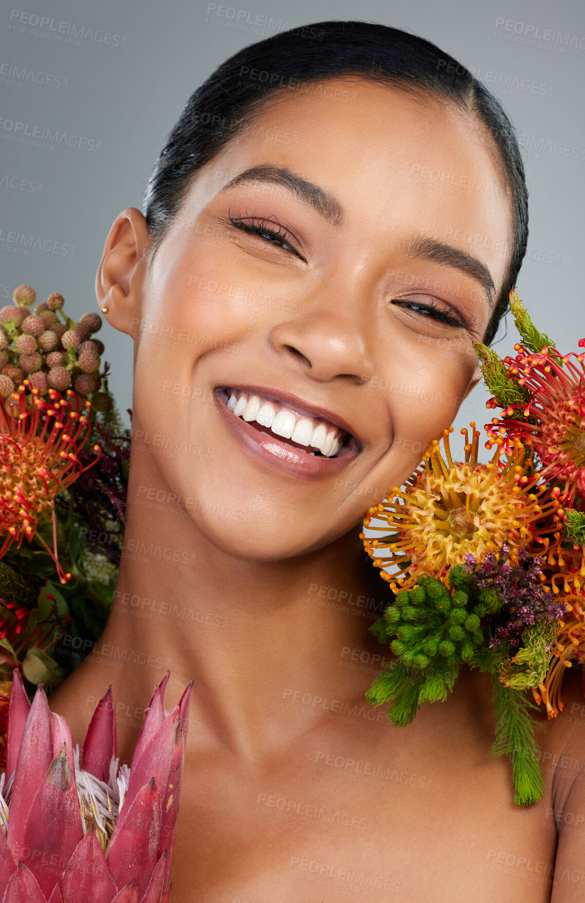 Buy stock photo Woman portrait, flowers and skincare in studio, beauty and organic treatment on gray background. Female person, vegan facial and confident for natural dermatology, fynbos plants and sustainability