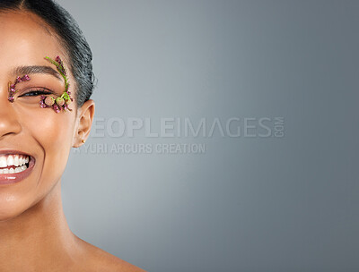 Buy stock photo Girl, flowers and cosmetics in studio portrait with makeup, beauty or leaves by eye by background. Woman, person and model with organic skincare in spring, floral plants or mockup space in Costa Rica