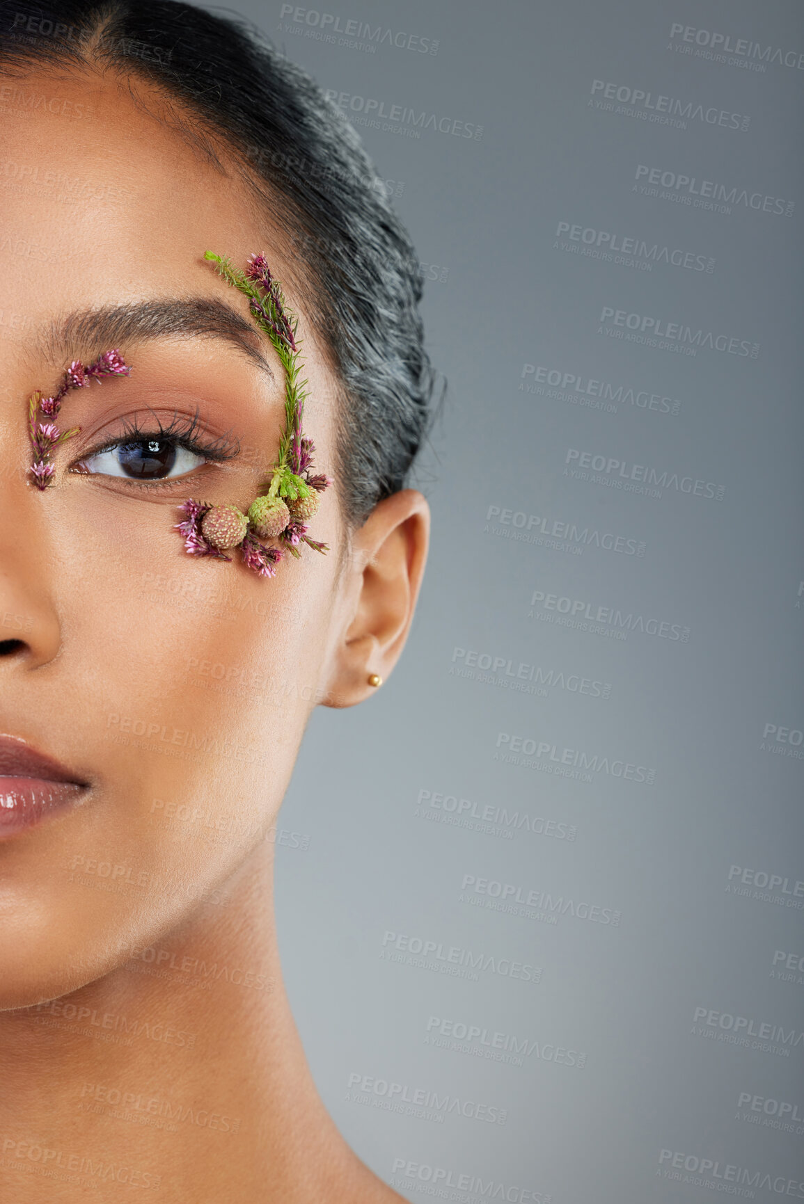 Buy stock photo Girl, flowers and cosmetics in studio portrait with makeup, beauty and leaves by eye by background. Woman, person and model in spring with organic skincare, plants and transformation in Costa Rica