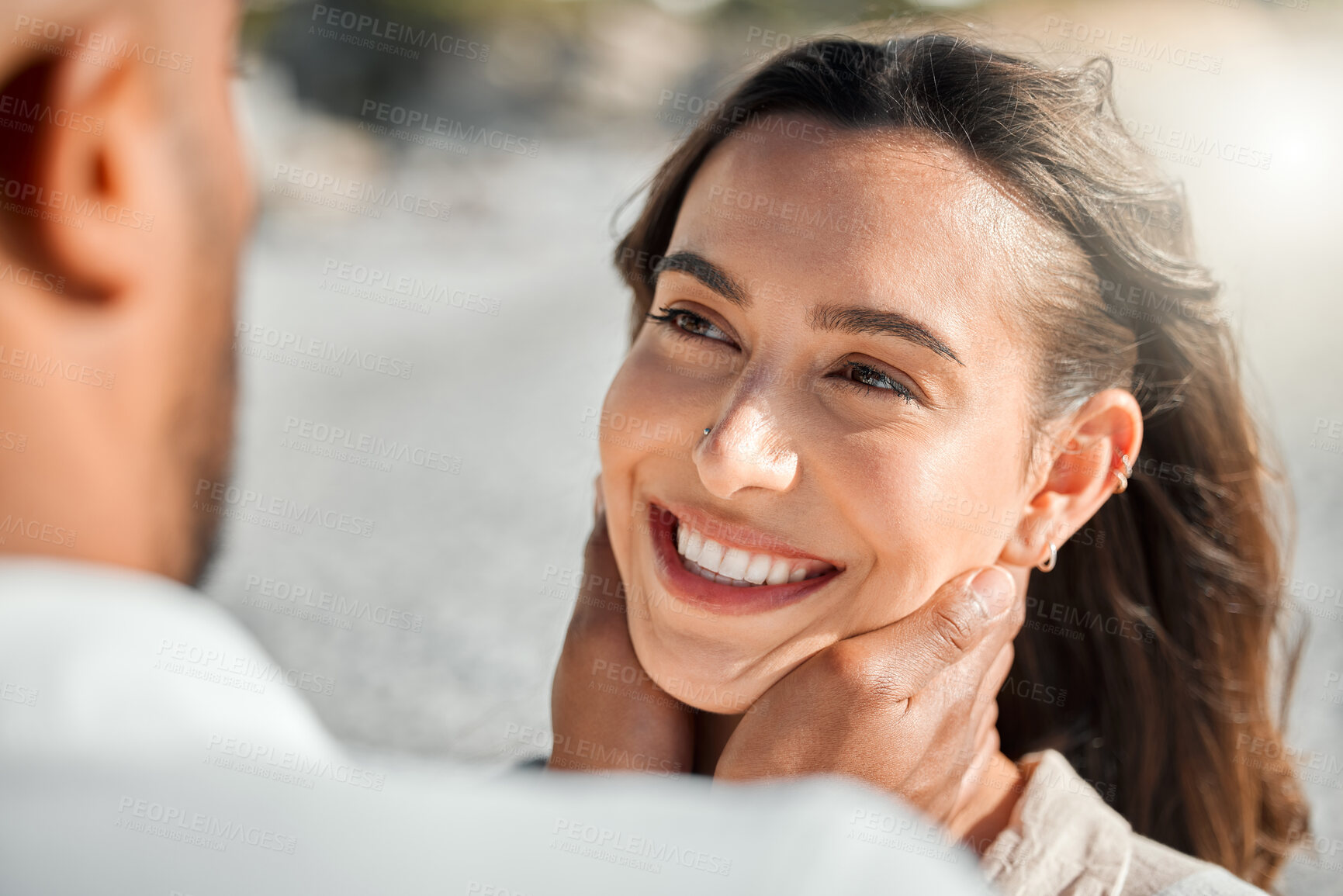 Buy stock photo Shot of a young couple spending time together at the beach