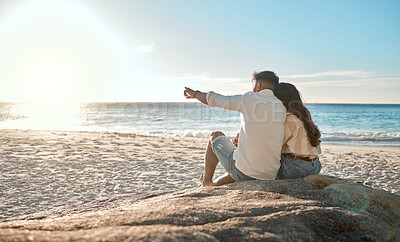 Buy stock photo Shot of a young couple spending time together at the beach