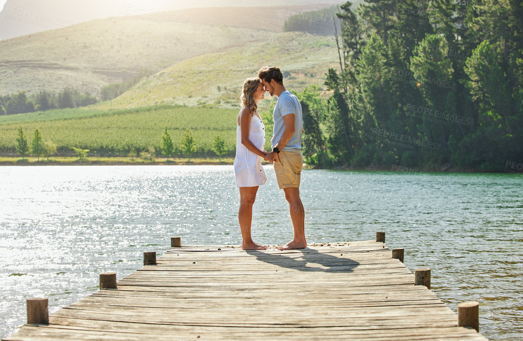 Buy stock photo Couple holding hands on jetty, relax by lake and summer, travel and adventure, love and care outdoor. People in relationship, trust and bonding on vacation, man and woman  are content with freedom