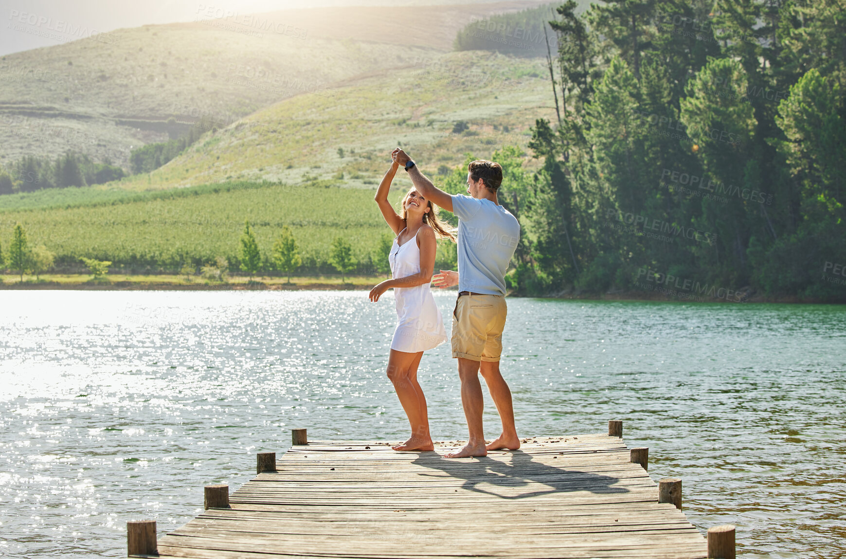 Buy stock photo Lake, dancing and happy nature couple on outdoor quality time together, fun countryside adventure or bonding getaway. Freedom peace, water and playful woman, man or romantic people dance on love date