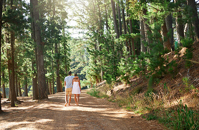 Buy stock photo Back, love and nature with a couple in the forest, walking together on a romantic date for bonding or adventure. Freedom, travel or hiking with a man and woman outdoor for a walk during summer