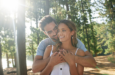 Buy stock photo Hug, happy and an affectionate couple in nature for romance, a date and walking in the morning. Smile, embrace and a man and woman with affection, hugging and content together in the woods or forest