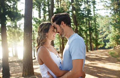 Buy stock photo Hug, happy and an affectionate couple in nature for peace, relaxation and date in the forest. Smile, embrace and a young man and woman hugging for love, care and affection on a vacation in the woods