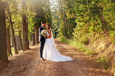 Buy stock photo Wedding, married and couple kiss in forest, garden and nature for celebration of love, care and commitment. Bride, groom and kissing in park for romance, bridal event and celebrate marriage ceremony 