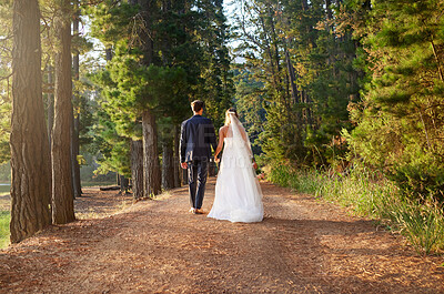 Buy stock photo Wedding, back and couple walking in forest, nature and park in celebration of union, care or marriage. Bride, groom and walk in garden, love and celebrate bridal event of commitment, support or trust