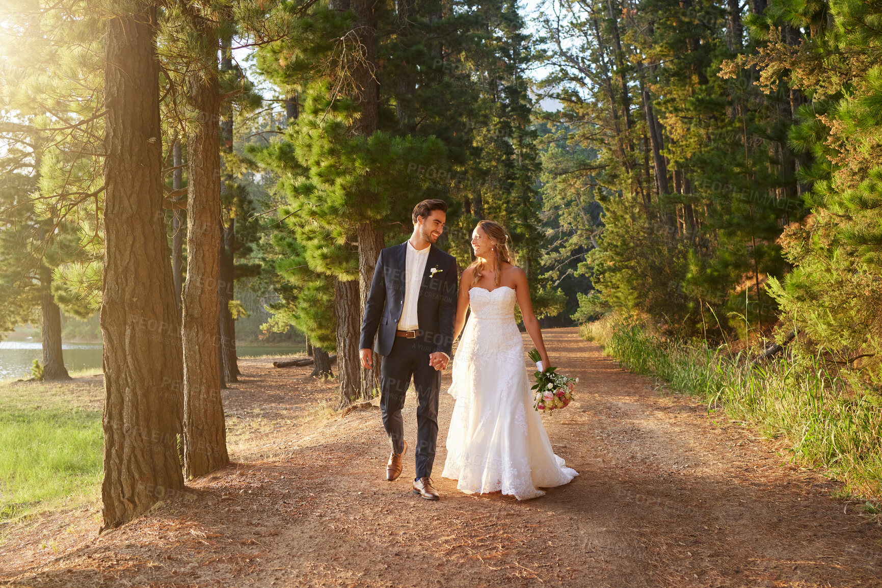 Buy stock photo Wedding, happy and couple walking in park, nature and forest for union celebration, care and marriage. Bride, groom and walk in woods, love and commitment to support, trust and smile together outdoor