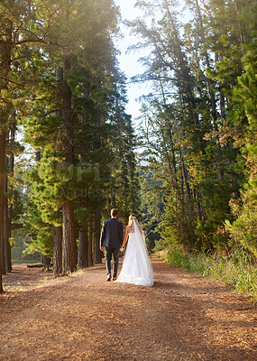 Buy stock photo Wedding, back and couple walking in forest, nature and park for union celebration, care and marriage. Bride, groom and walk in woods, love and bridal event of commitment, support and trust of partner