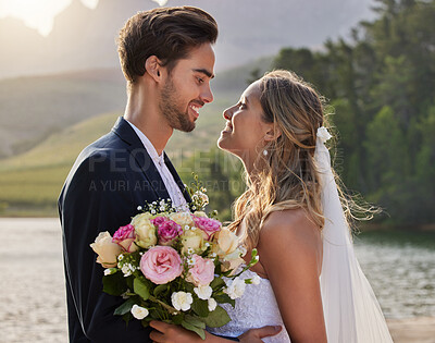 Buy stock photo Love, nature wedding and happy couple kiss at unity commitment, romantic ceremony or marriage event at outdoor lake. Hugging, flower bouquet and countryside romance of man and woman in solidarity