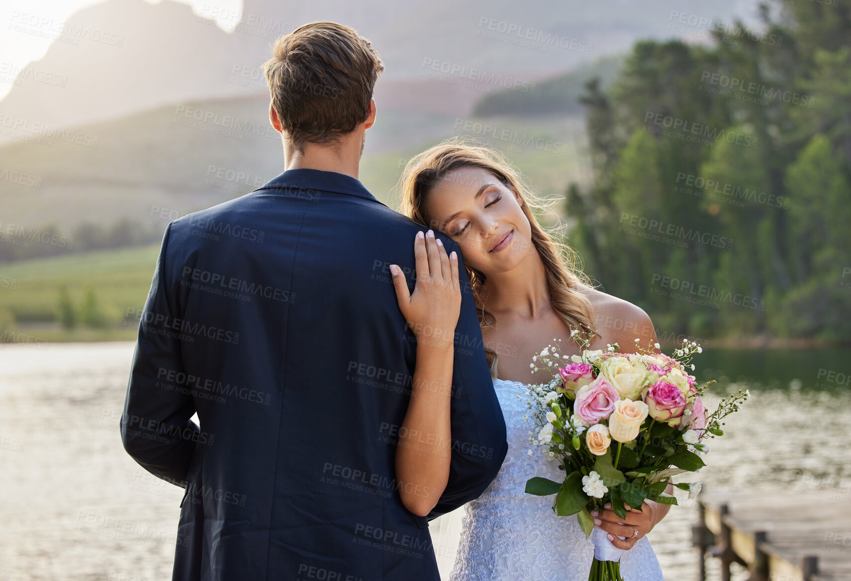 Buy stock photo Happy, affection and couple at lake wedding for a ceremony, celebration and romantic event. Love, smile and a woman hugging a man, holding and looking peaceful together after marriage in nature