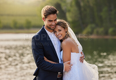 Buy stock photo Happy wedding couple, hug and smile by water lake for romantic honeymoon getaway in nature. Man and woman hugging in happiness for marriage relationship or embracing loving commitment in the outdoors