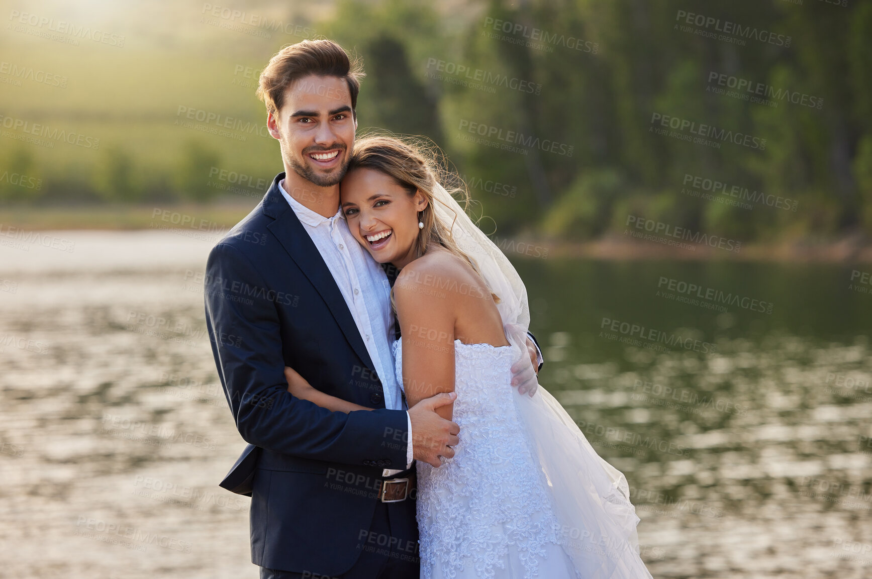 Buy stock photo Happy wedding couple, portrait and hug by lake for romantic honeymoon getaway in nature. Man and woman hugging in happiness for marriage relationship or loving embrace in commitment in the outdoors