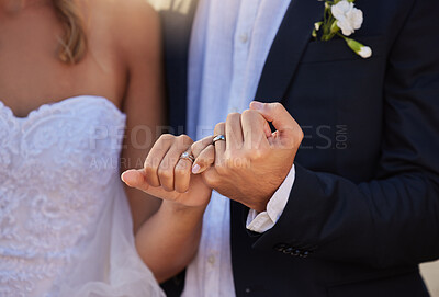Buy stock photo Wedding, rings and closeup of a couple with a pinky promise for love, loyalty and marriage. Romance, hands and married man and woman with jewellery for their union and bond at a romantic event.