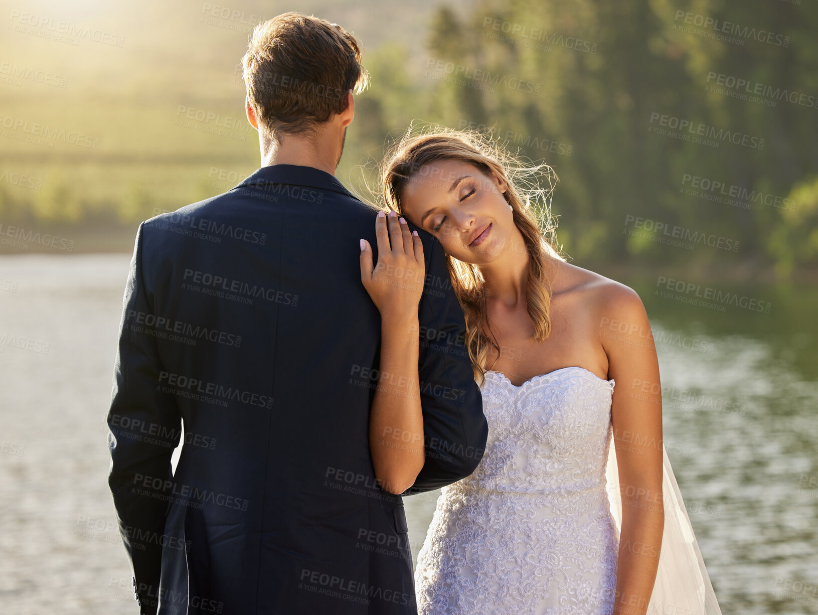 Buy stock photo Affection, love and a couple at a lake wedding with comfort, content and celebration of marriage. Calm, peace and a man and woman embracing after a relationship commitment ceremony in nature