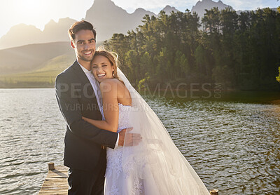 Buy stock photo Happy, hug and portrait of a married couple by a lake for a ceremony, celebration and marriage. Smile, affection and a bride and groom hugging after wedding and relationship commitment in nature