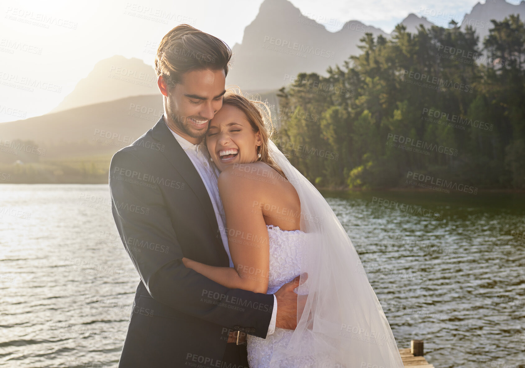 Buy stock photo Happy, hug and couple at a lake wedding with love at a ceremony, celebration and marriage. Smile, affection and a man and woman hugging after romantic relationship commitment in nature together