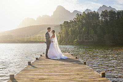Buy stock photo Full length shot of an affectionate bride and groom outside on their wedding day