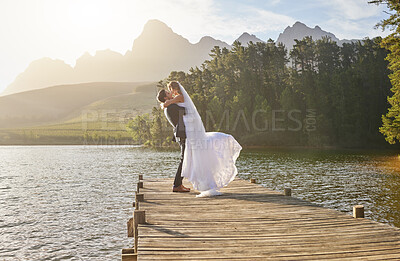 Buy stock photo Full length shot of an affectionate bride and groom outside on their wedding day