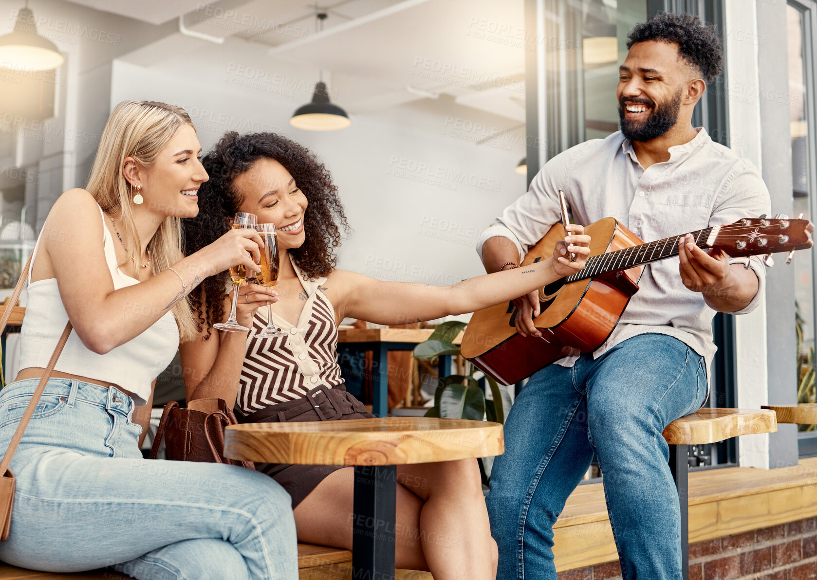 Buy stock photo Shot of two friends taking selfies together at a cafe while a man plays guitar