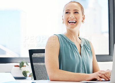 Buy stock photo Shot of an attractive young businesswoman sitting alone in the office and using her laptop