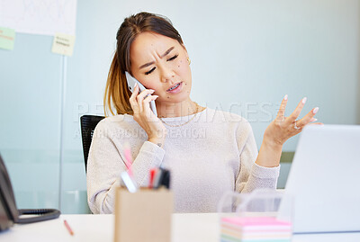 Buy stock photo Shot of an attractive young businesswoman sitting alone in the office and looking confused while using technology