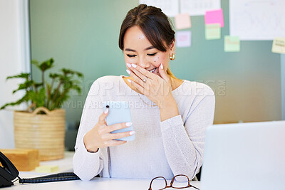 Buy stock photo Shot of an attractive young businesswoman sitting alone in the office and giggling while using her cellphone
