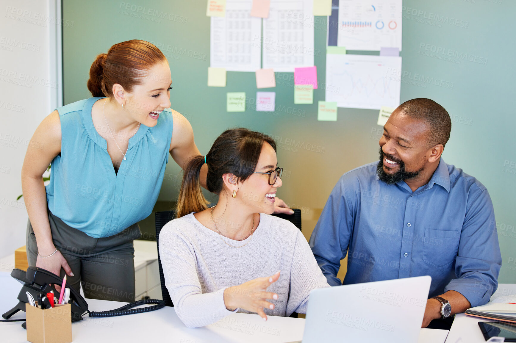 Buy stock photo Shot of a diverse group of businesspeople brainstorming while using a laptop in the office