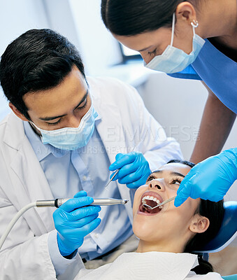 Buy stock photo Shot of a dentist working on his young patient