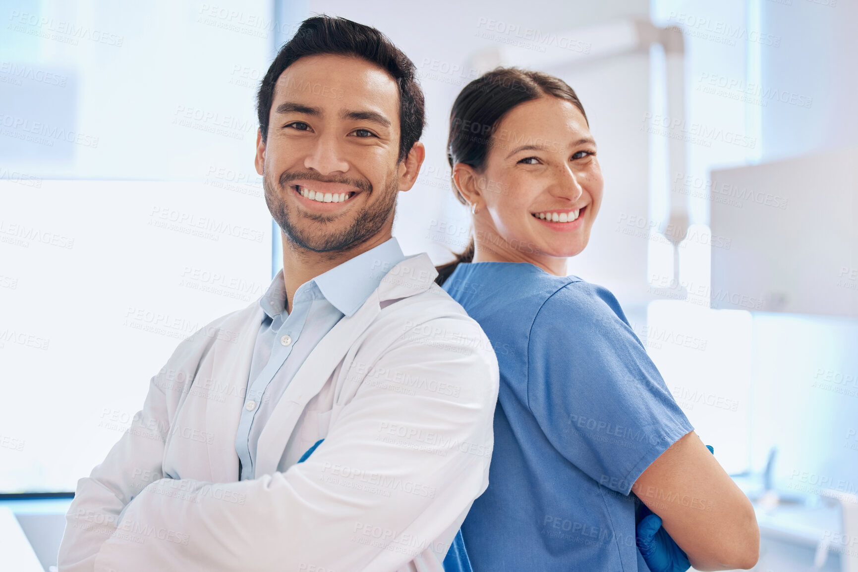 Buy stock photo Shot of a young dentist with his assistant